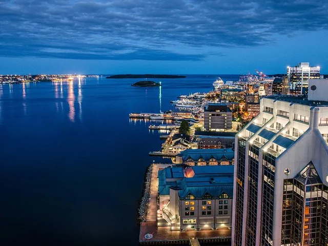 Elevated view of a harbor and city waterfront at dusk.
